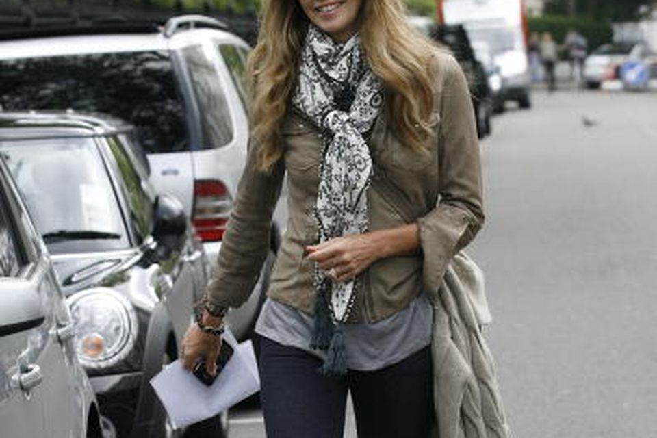 Elle Macpherson returns to her car after taking her child to
