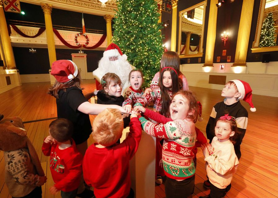 Santa gets some help turning on the Christmas tree in St Patrick's Hall at Christmas at Dublin Castle. Pic: Mark Stedman