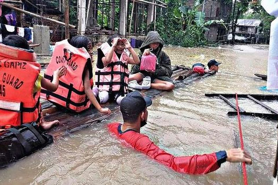 Residents are evacuated by rescuers in a flooded village in Panitan, Panay island Photo: Philippine Coast Guard via AP.