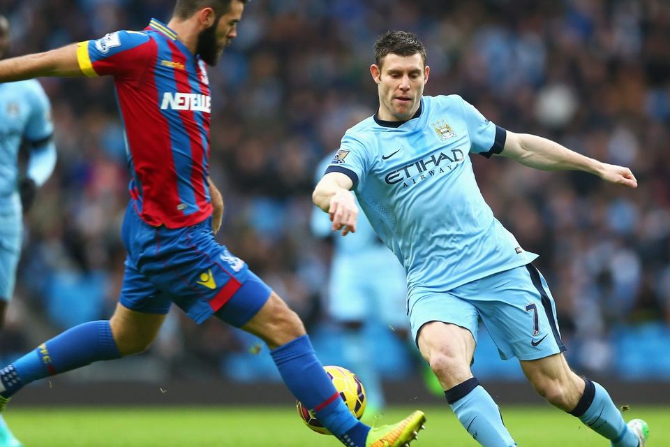 Manchester City's James Milner is challenged by Crystal Palace midfielder Joe Ledley during their Premier League clash at the Etihad. Photo: Michael Steele/Getty Images