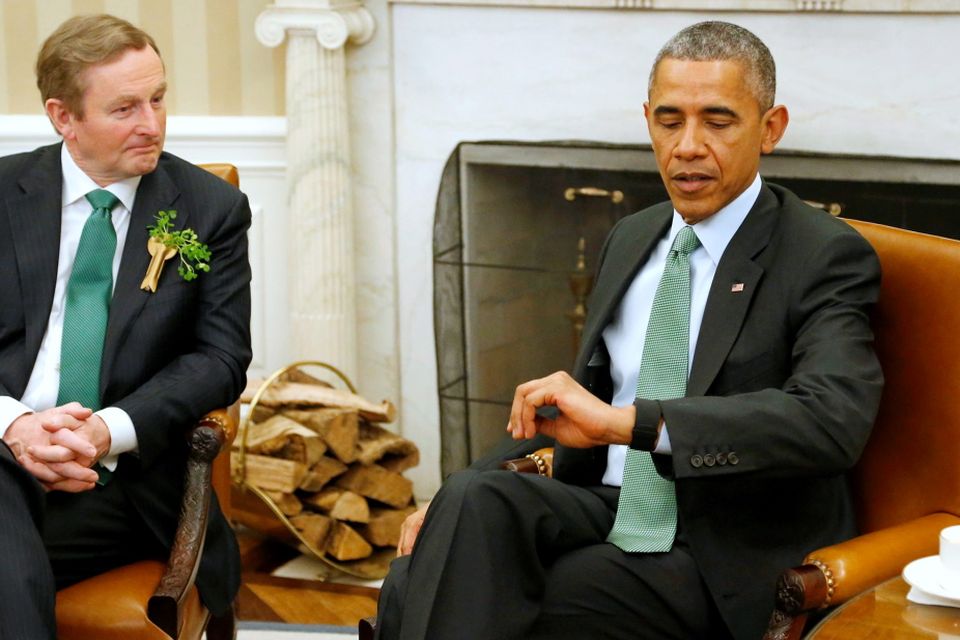 U.S. President Barack Obama (R) checks his watch as he and Ireland's Prime Minister Enda Kenny prepare to depart for a luncheon at the U.S. Capitol after their meeting in the Oval Office as part of a St. Patrick's Day visit at the White House in Washington March 17, 2015. REUTERS/Jonathan Ernst