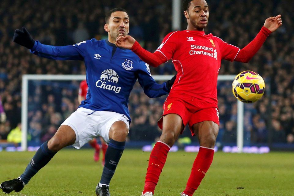 Aaron Lennon (R) of Everton challenges Raheem Sterling of Liverpool during their English Premier League soccer match at Goodison Park, Liverpool