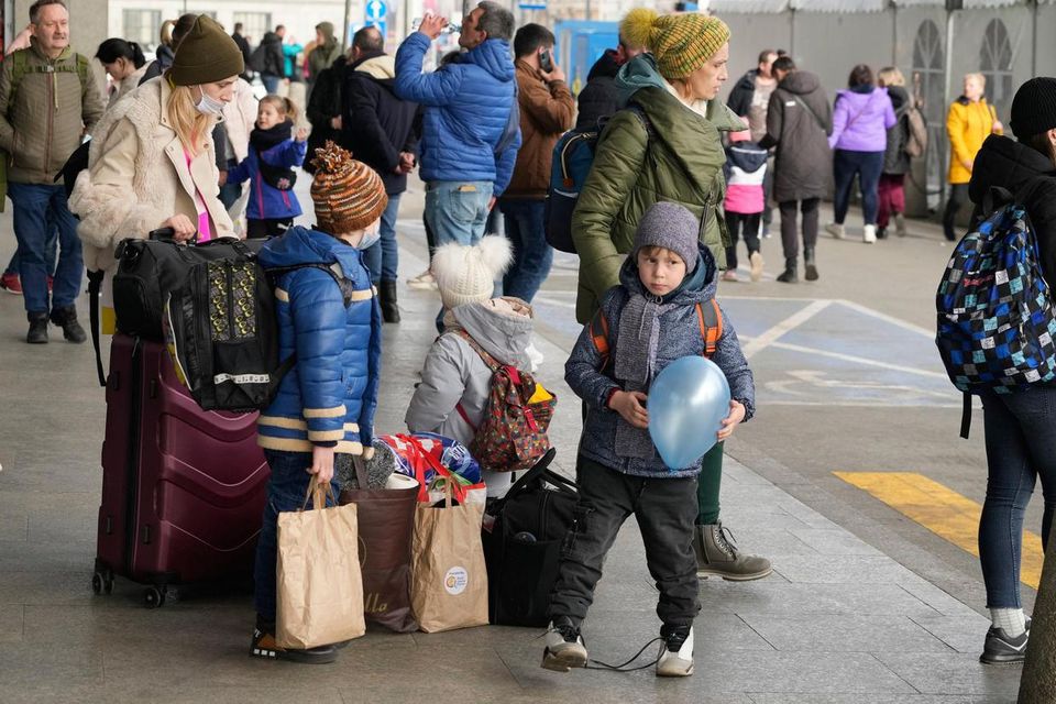 Ukrainian refugees wait to board a train to Warsaw in Poland