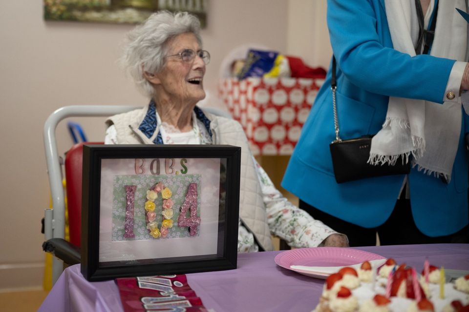 The late Babs Mearns at her 104th birthday party, a commemorative decoration in the foreground. Photo: Liz White