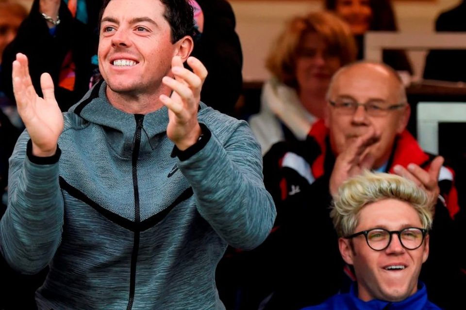 Golfer Rory McIlroy and One Direction’s Niall Horan cheering
on the teams in last night’s Leinster-Ulster Pro12 semi-final. SPORTSFILE
