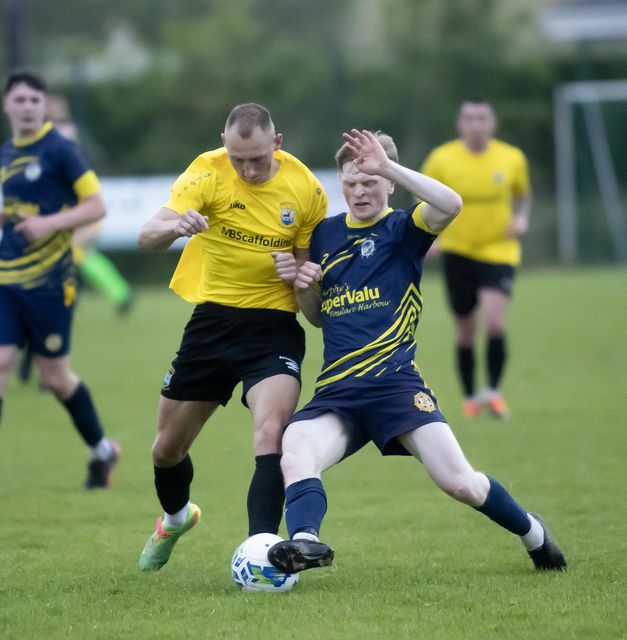 Eryk Borowiec of New Ross Celtic and Cian Buttle (Rosslare Rangers) battle for the ball.