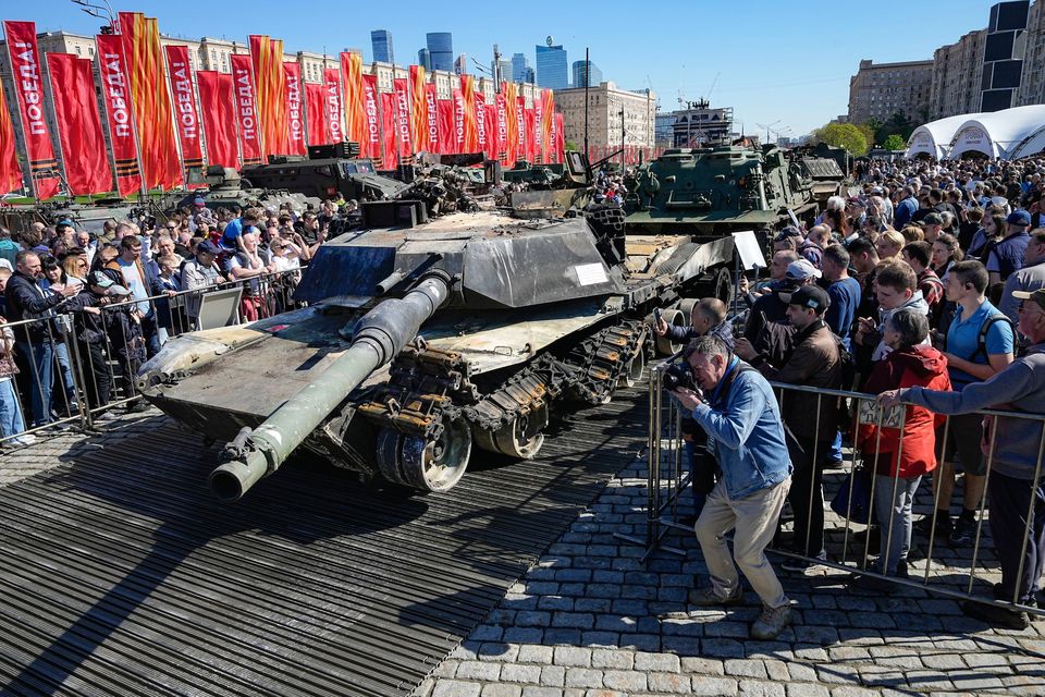 Visitors take photos of a captured US-made M1A1 Abrams tank which is seen on display in Moscow yesterday. Photo: AP