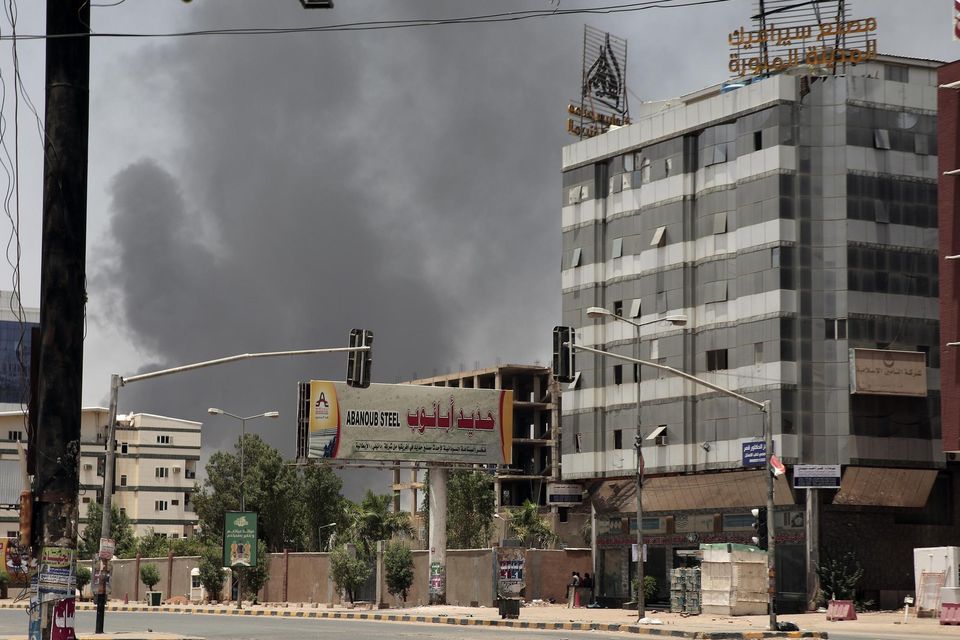Smoke is seen in a neighbourhood in Khartoum, Sudan (Marwan Ali/AP)