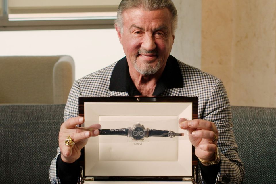 Sylvester Stallone with one of his watches being auctioned (Sotheby’s/PA)