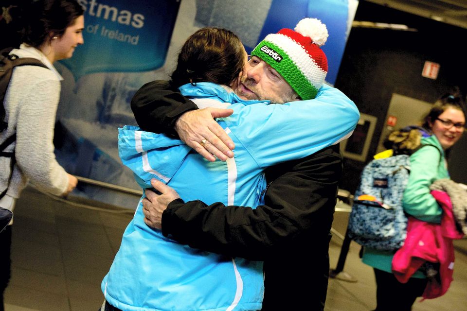 28/12/2014. Pictured passengers embrace after arriving into Dublin airport from Chambery, France where they were stranded after a ski trip. Photo: El Keegan