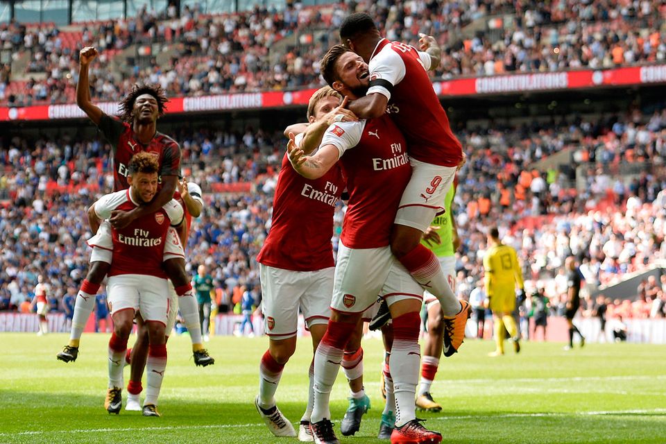 Arsenal's Olivier Giroud celebrates with teammates after scoring the winning penalty