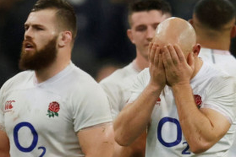 England’s Willi Heinz looks dejected as teammates look on after the defeat to France who have become better organised under new coach Fabien Galthie