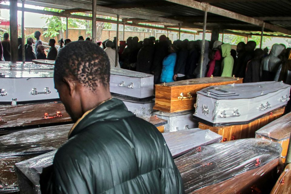 Relatives search for the bodies of their loved ones at a mortuary in Blantyre, Malawi. Photo: Reuters/Eldson Chagara