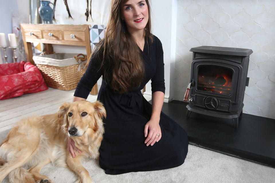 Alexa O'Byrne and her dog with her Stanley stove.