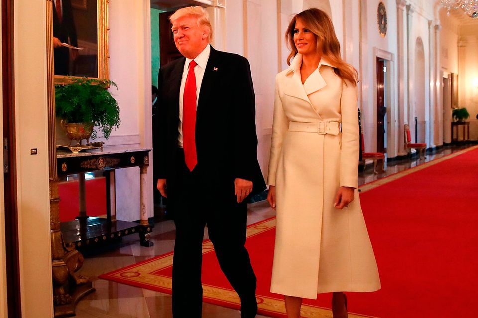 U.S. President Donald Trump and first lady Melania Trump walk into the East Room to attend an event celebrating Women's History Month, at the White House March 29, 2017 in Washington, DC.  (Photo by Mark Wilson/Getty Images)