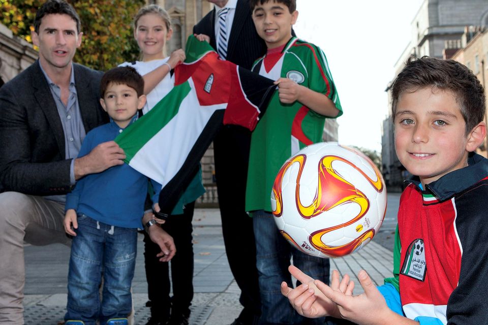 Former Ireland manager Brian Kerr and former rugby international Trevor Hogan launch 'Gaza Kids to Ireland' with the help of a group of Palestinian footballers in Dublin yesterday