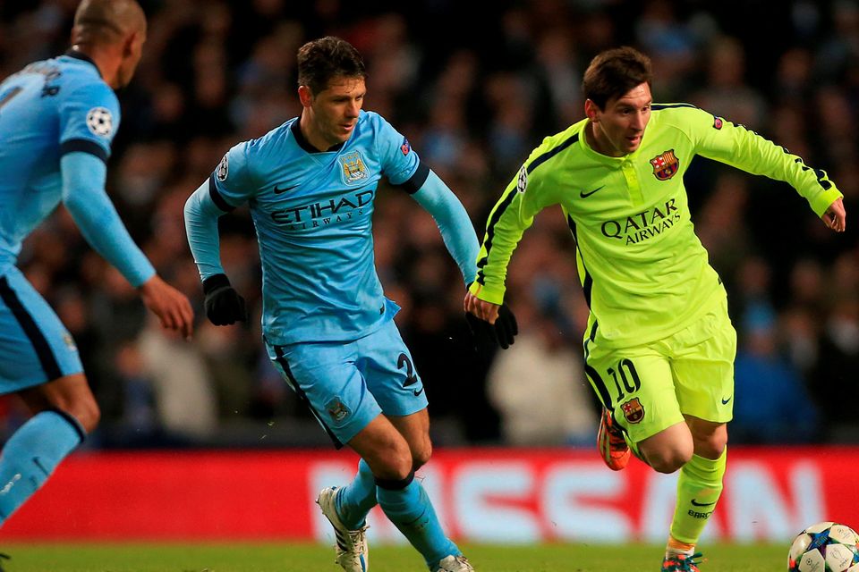 Barcelona's Lionel Messi (right) in action with Manchester City's Martin Demichelis