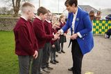 thumbnail: Students welcome Minister for Education Foley to Scoil Naomh Eirc Kilmoyley this past Monday for the official opening of the school's new 'outdoor classroom'.