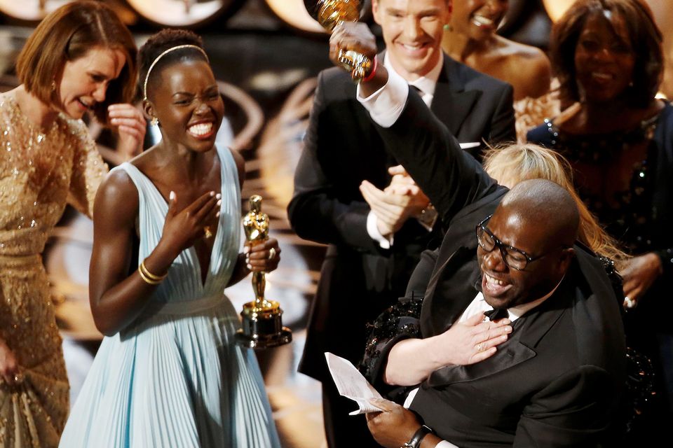 Director and producer Steve McQueen celebrates after accepting the Oscar for Best Picture with Lupita Nyong'o (L) at the 86th Academy Awards in Hollywood, California March 2, 2014.  REUTERS/Lucy Nicholson