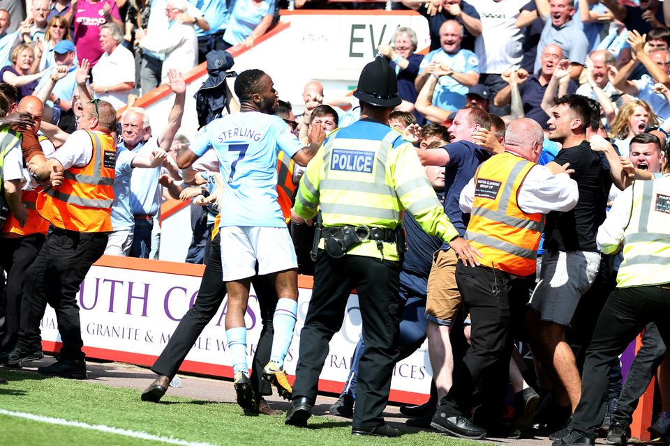 Raheem Sterling celebrates with the crowd after his late winner, earning a second booking
