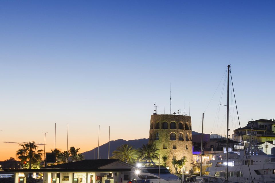 Puerto Banus harbour at twilight with reflection in the still water in Andalusia, Spain