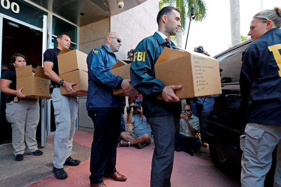 FBI agents carry boxes from the headquarters of CONCACAF after it was raided in Miami Beach, Florida. Photo: Getty Images