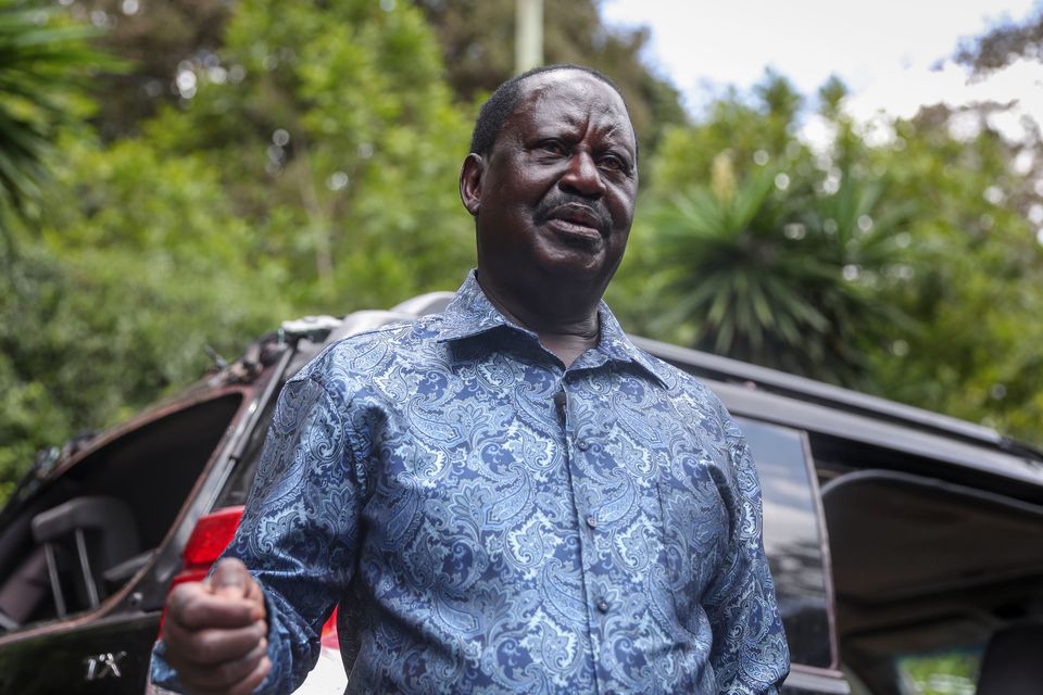 Kenya’s opposition leader Raila Odinga speaks next to one of his vehicles he says was struck by a teargas canister fired by riot police, at his home in Nairobi, Kenya Friday, March 31, 2023. In an interview with The Associated Press on Friday, Odinga denounced the point-blank firing of a tear gas canister at local journalists during his latest anti-government protest as a “primitive act of intolerance” and vowed to go to court over what he called an attempt on his own life. (AP Photo/Brian Inganga)