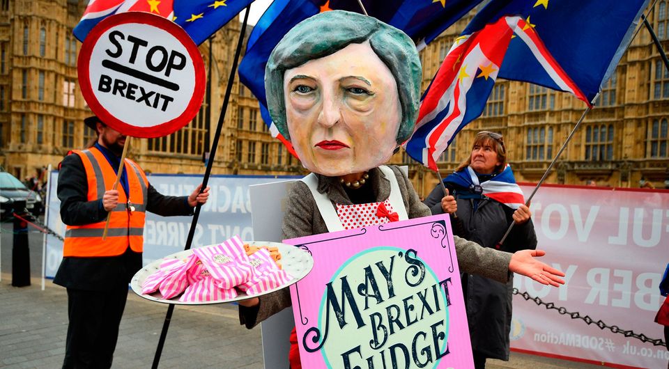 Protest: A demonstrator dressed as Theresa May sells Brexit fudge at Westminster. Photo: PA