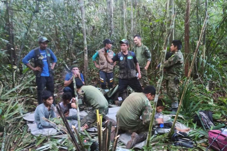 Men tend to the four children who were missing after a deadly plane crash in the Solano jungle. Photo: AP