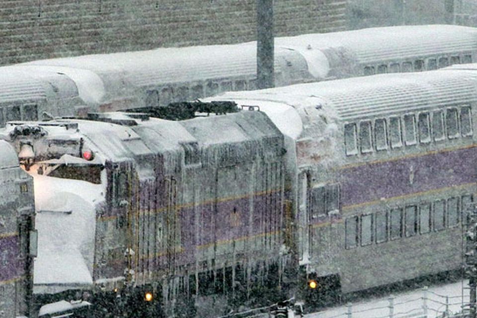 Trains sit idle early in Boston due to high winds and the nearly two-feet of snow that fell in the area overnight.