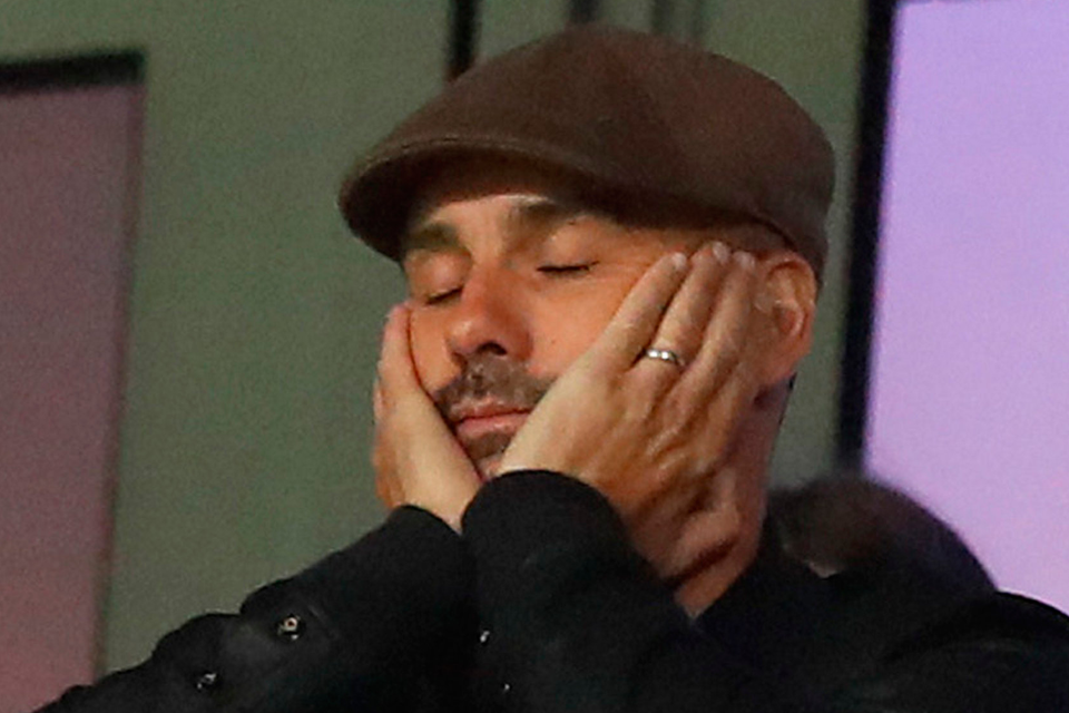 Eyes down: It was a frustrating night for Pep Guardiola as he watched Manchester City lose 2-1 against Lyon from the stands. Photo: PA