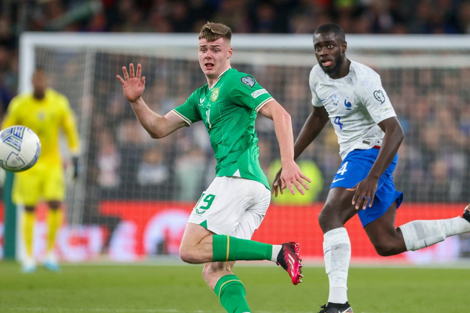 Ireland's Evan Ferguson, left, and France's Dayot Upamecano go for the ball during the Euro 2024 group B qualifying soccer match between Ireland and France at the Aviva Stadium in Dublin, Ireland, Monday, March 27, 2023. (AP Photo/Peter Morrison)