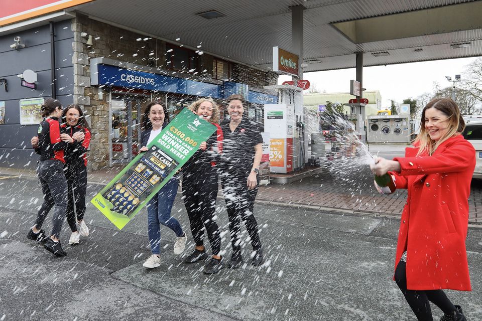 Joyous staff members from Cassidy’s XL in Carrickmacross, Co Monaghan crack open a bottle of champagne in celebration at news the store sold an All Cash Gift scratch card with a top prize of €300,000. Photo: Pat Byrne / Mac Innes Photography