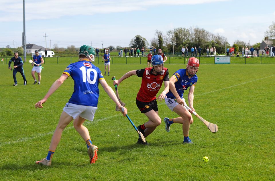 Wicklow's Larry Kinsella and Fionn D'Arcy (10) battle with Down's Rory McCamphill in Darver. 
