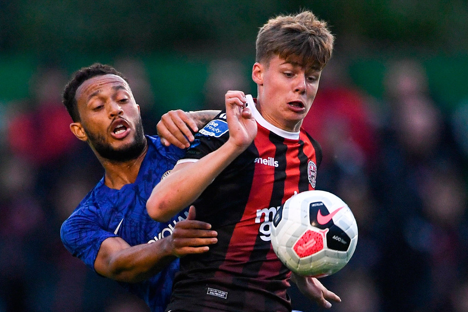 Fourteen-year-old Evan Ferguson, son of former League of Ireland player Barry, holds off Lewis Baker during Bohemians’ friendly against Chelsea at Dalymount Park last night. Photo: Ramsey Cardy/Sportsfile
