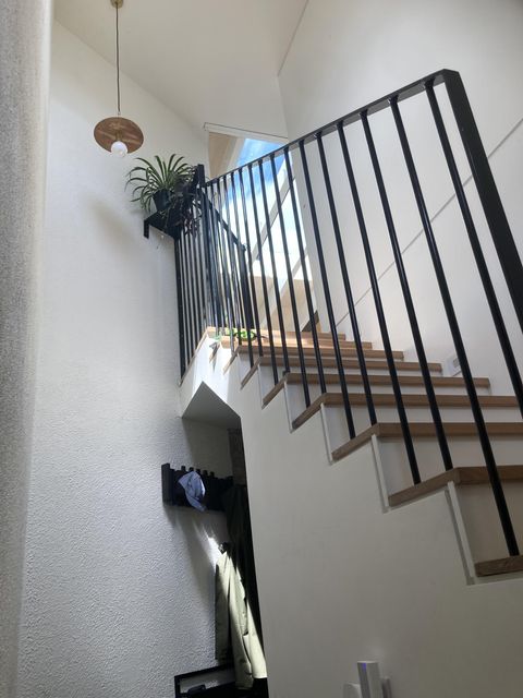 The house has stairs leading up to the kitchen and living area.