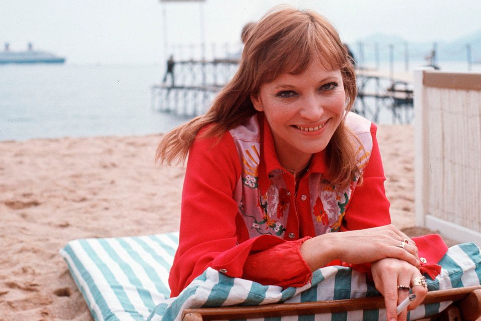 In this file photo taken on May 1, 1973 Danish born actress Anna Karina poses at the beach during the 62nd Cannes Film Festival. (Photo by -/AFP via Getty Images)