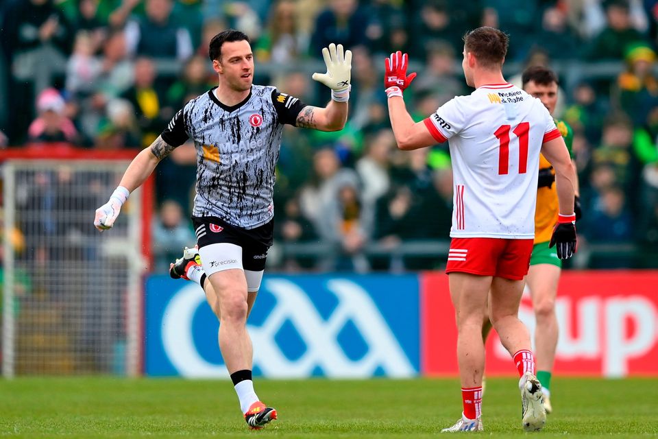 Tyrone goalkeeper Niall Morgan, left, is congratulated by Kieran McGeary after scoring a point from a free. Photo: Stephen McCarthy/Sportsfile