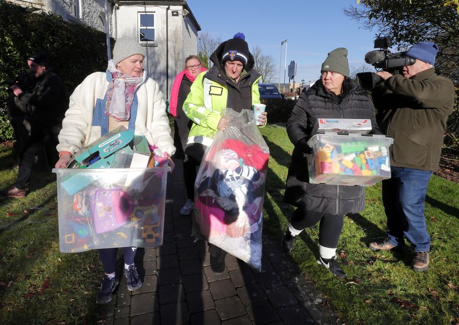 Local women carry bags of toys and clothes to the main door at Racket Hall in Roscrea, Co Tipperary. Photo: Frank McGrath