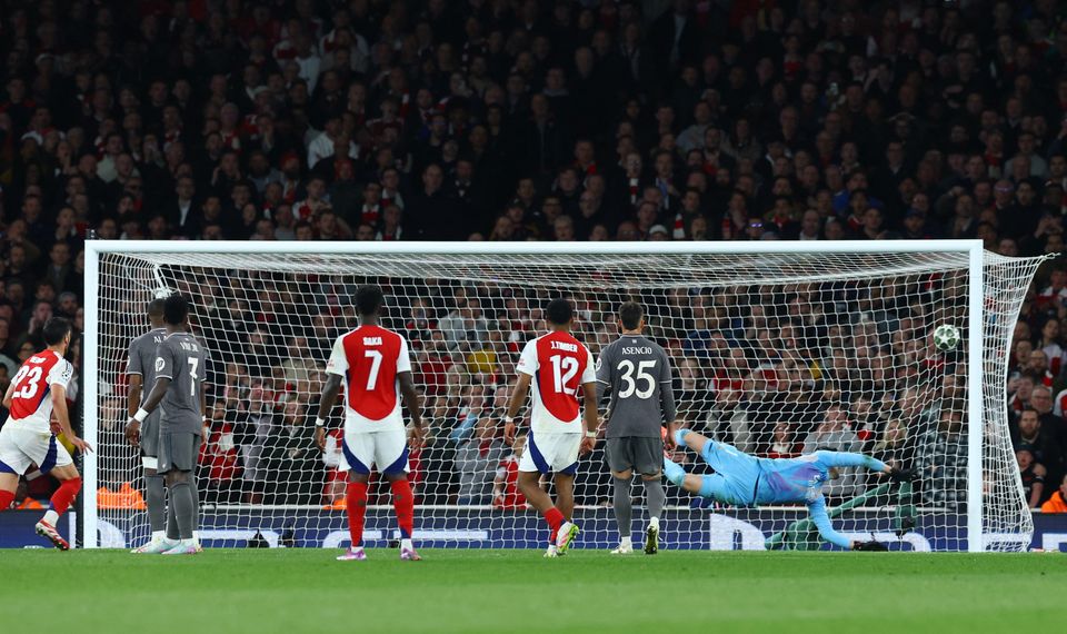 Arsenal's Declan Rice scores their second goal from a free kick past Real Madrid's Thibaut Courtois