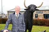 thumbnail: Hugh Nolan with a teak bull that is also up for auction