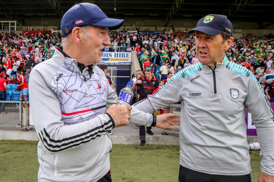 Kerry manager Jack O'Connor shakes hands with Louth manager Mickey Harte, left, after the All-Ireland Senior Football Championship Group 1 Round 3 match in Portlaoise