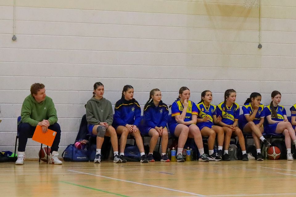 The Colaiste Bhríde bench look on as the action unfolds.