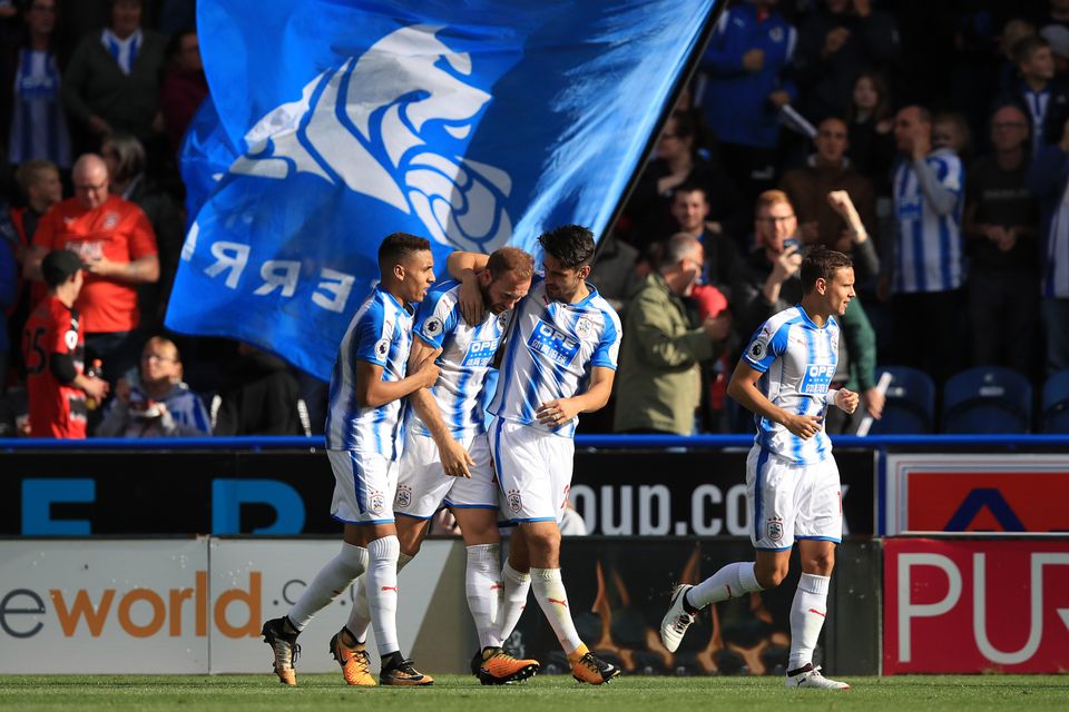 Huddersfield's Laurent Depoitre, second left, celebrates with his team-mates after scoring against Leicester