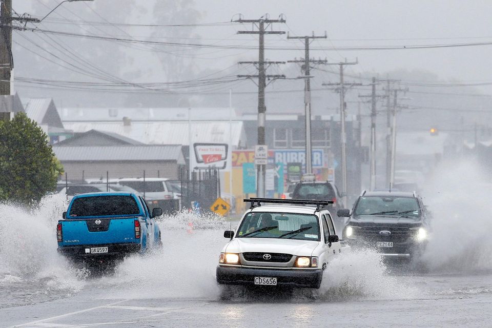 Cars move through flooded roads in the northern New Zealand city of Whangarei as Tropical Cyclone Gabrielle hits the Northland. AP
