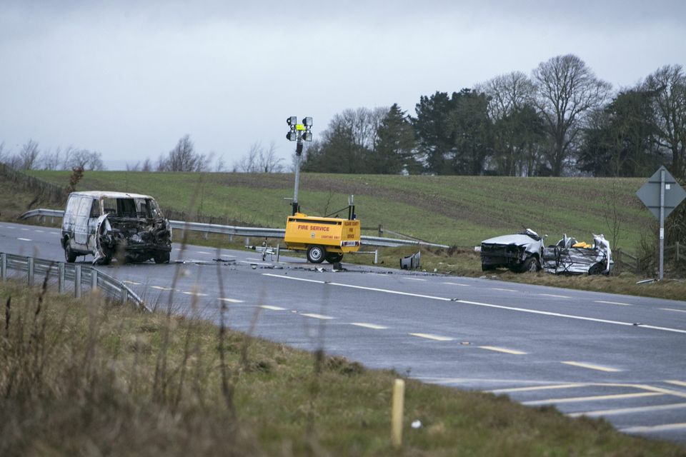 Four young bodies lying on the side of the road with their whole