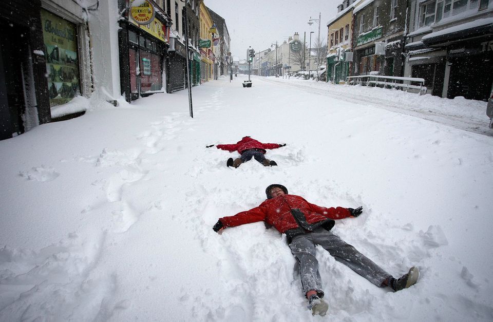 James and Gemma Kavanagh practice their snow angels on Main street, Arklow, Co Wicklow. Photograph: Garry O'Neill