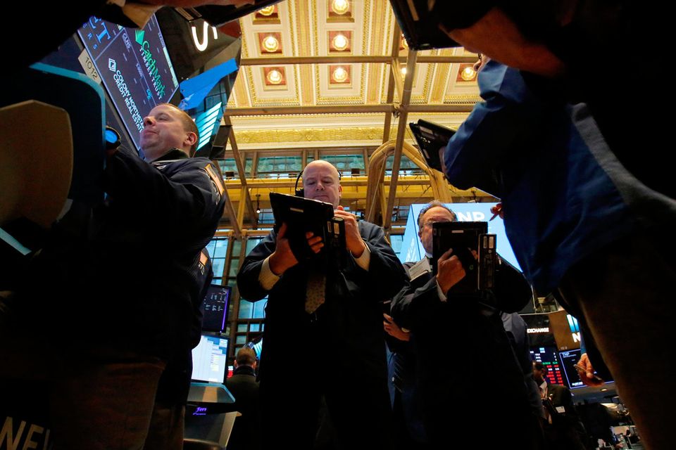 Traders work on the trading floor at the New York Stock Exchange (NYSE)