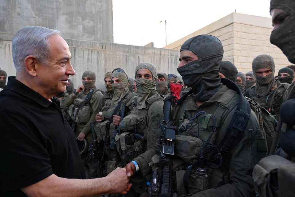 Israeli prime minister Benjamin Netanyahu with masked IDF soldiers. Photo: Reuters