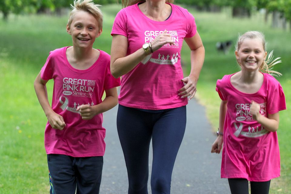 Vivienne Connolly, her son Ben (11), and daughter Katie (8) train for the Great Pink Run for Breast Cancer Ireland in the Phoenix Park. Photo: Arthur Carron